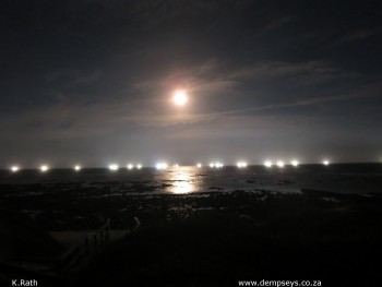 shaky shot of chokka boats under the shine of the full moon