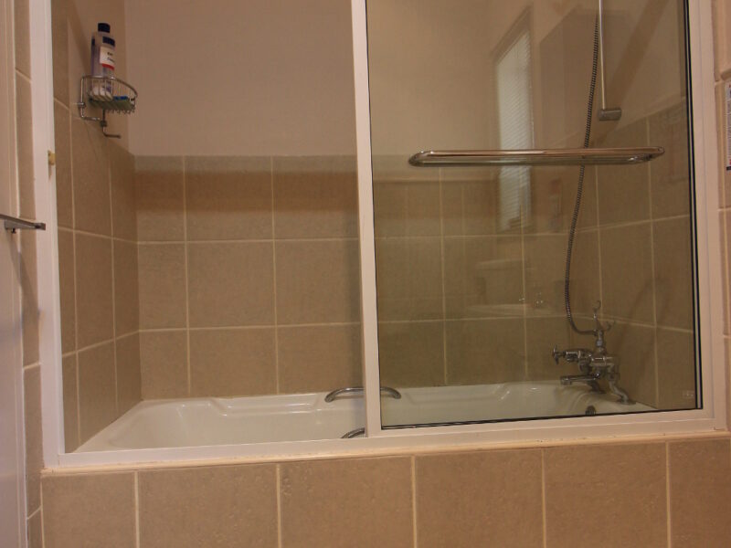 shower over bath, sturdy glass sliding doors, 2 steps into bath. family room no.1