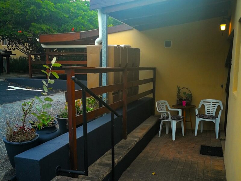 under cover patio area outside twin room no.3. three steps to front door of room 3. no steps inside, one step into the shower.
